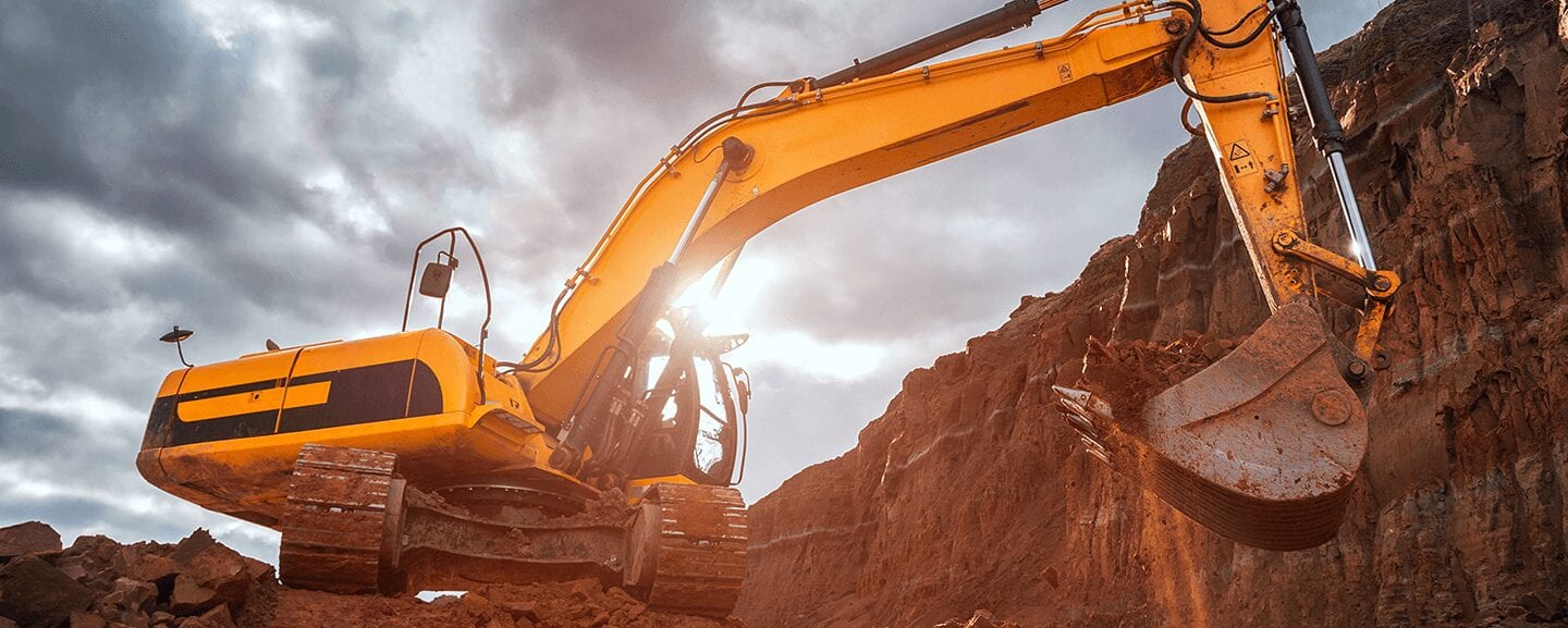 yellow excavator digging